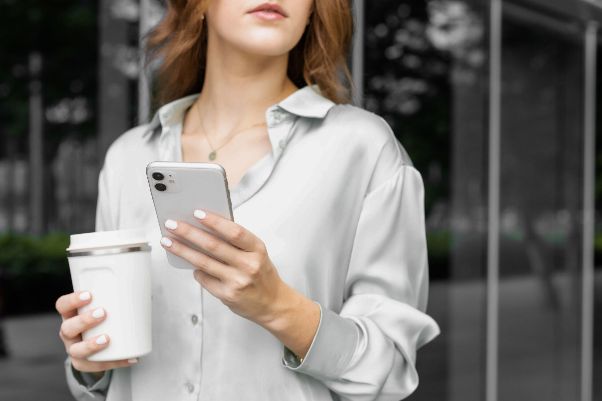 Woman on phone with coffee in hand